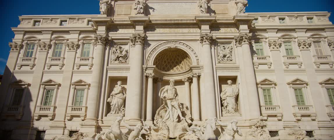 Statues sit in front of the building
