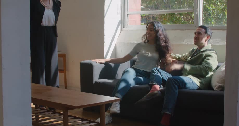 A realtor is showing an apartment to a couple