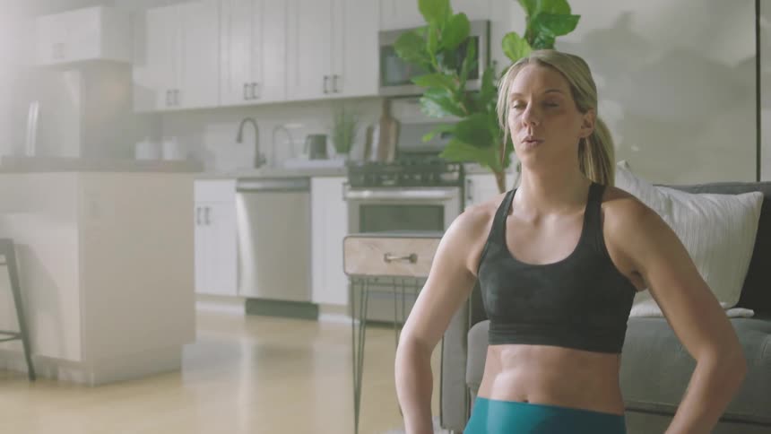 Man and woman are exercising indoors during the day