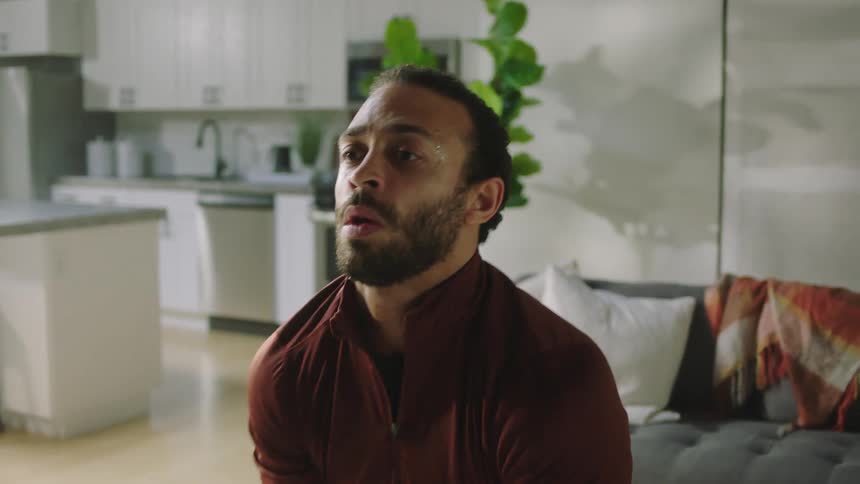 A man working out with a kettlebell in a living room