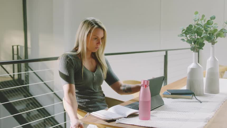 A woman is working in an office building during the daytime