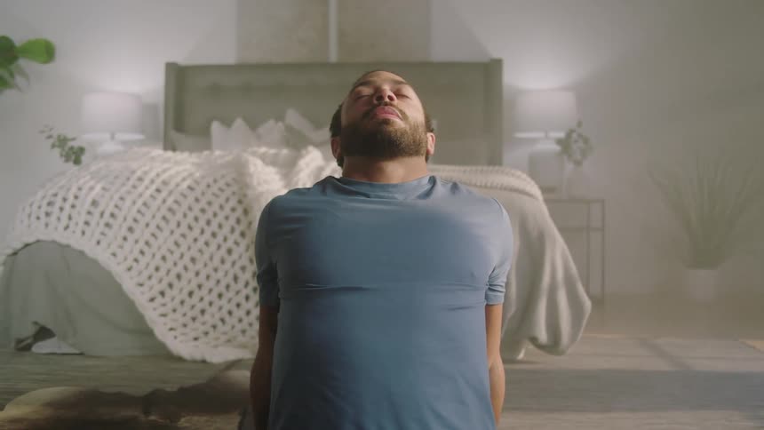 A man meditating in a room