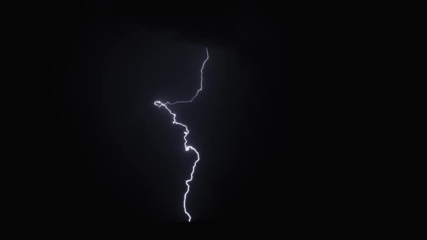 Lightning bolts flash and strike in the night sky