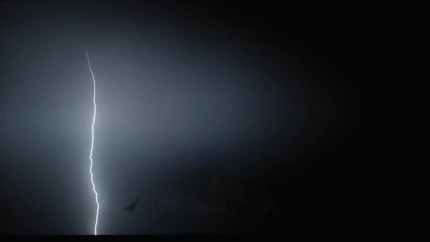 Lightning flashing in a dark night sky