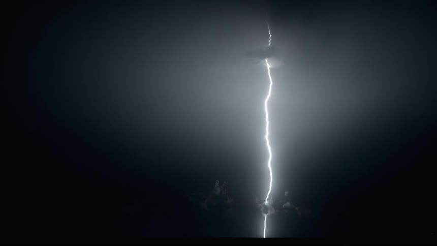 A thunderstorm is happening at night with lightning