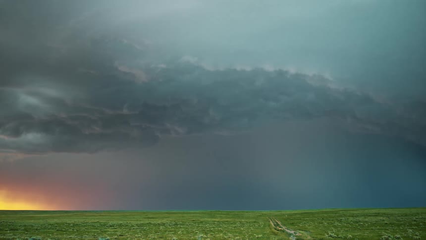 Lightning flashing during a rainstorm over a grassy plain