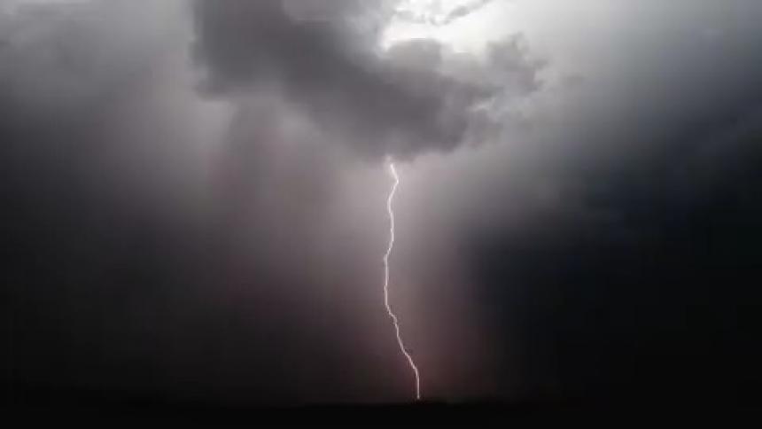 A flash of lightning lights up the night sky