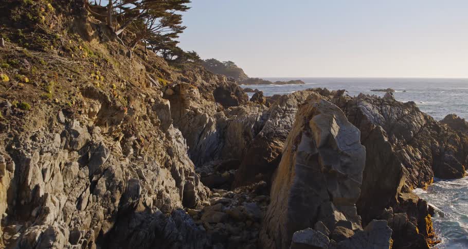 Waves rolling in to a cliff on the shore