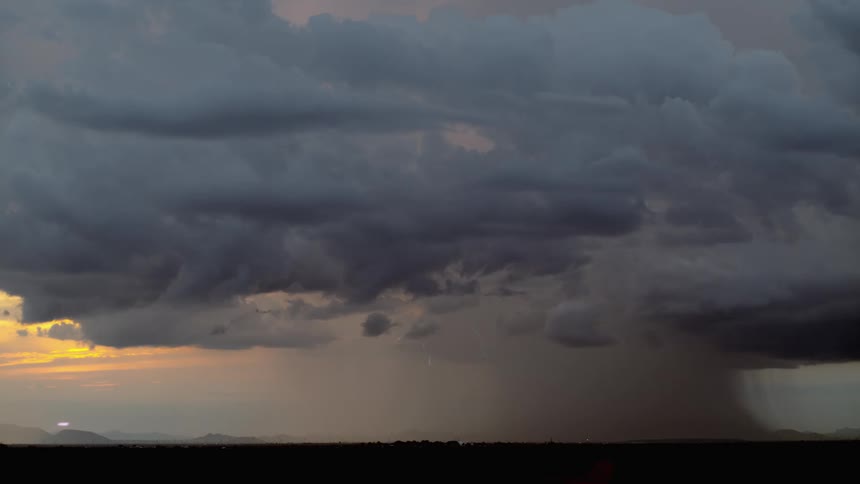 A tornado is forming over a landscape area