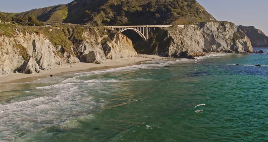 Aerial view of cliff bridge next to beach
