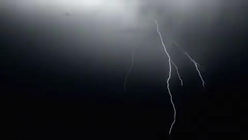 A thunderstorm is happening in the atmosphere at night