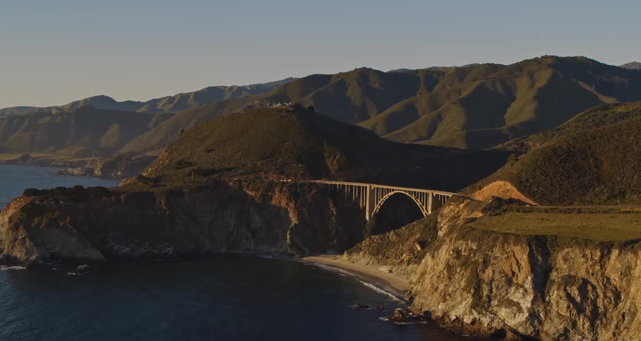 Aerial view of a mountain landscape is displayed at dusk