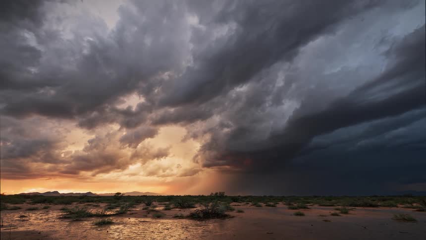 A storm is moving fast over the landscape at dusk