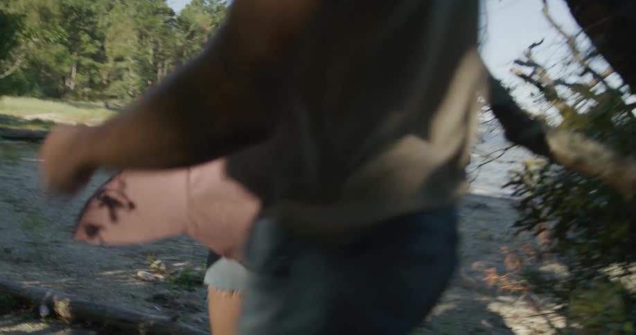 A group of friends are running towards the beach together