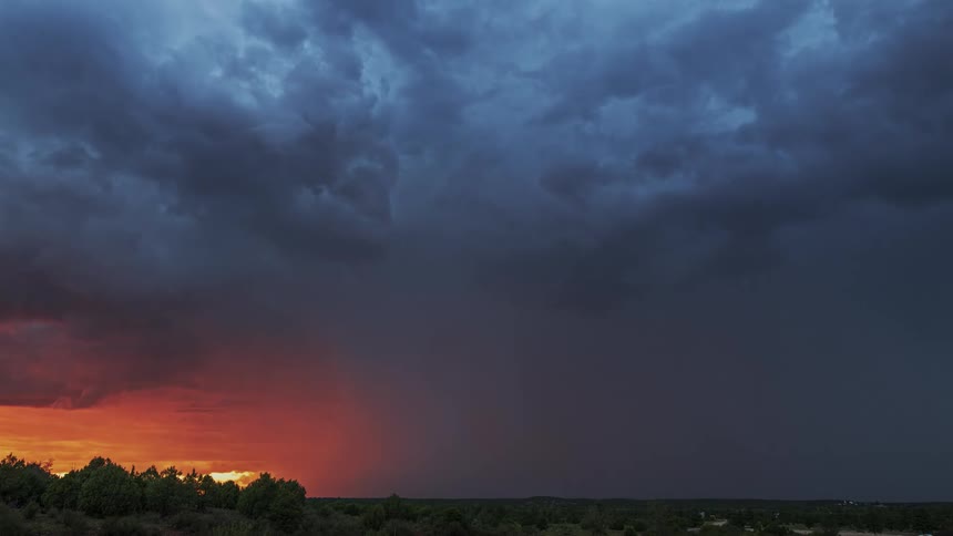 Lightning flashing in the sky over a field during a rainstorm