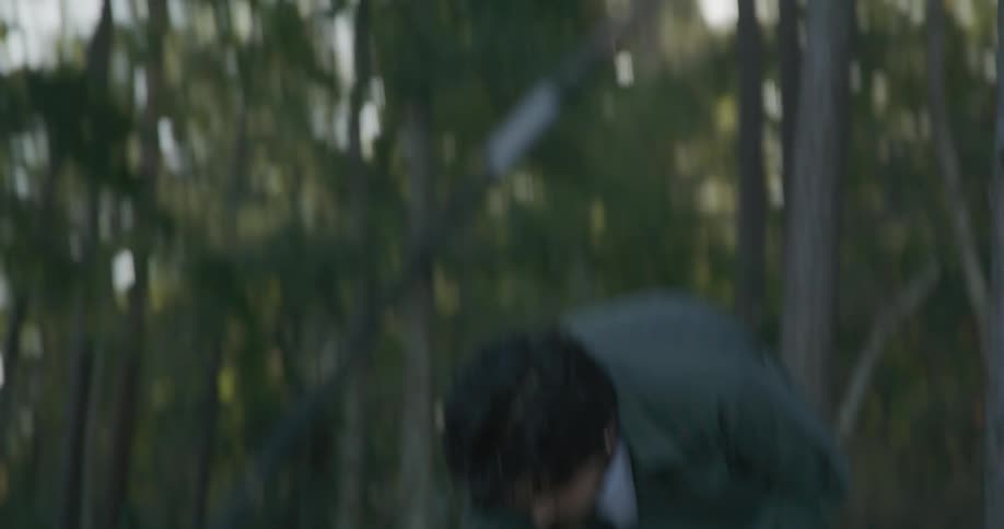 Man and woman are in the woods and putting up a tent