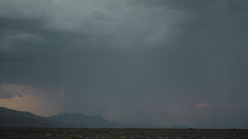 On the horizon dark gray storm clouds are gathering with lightning