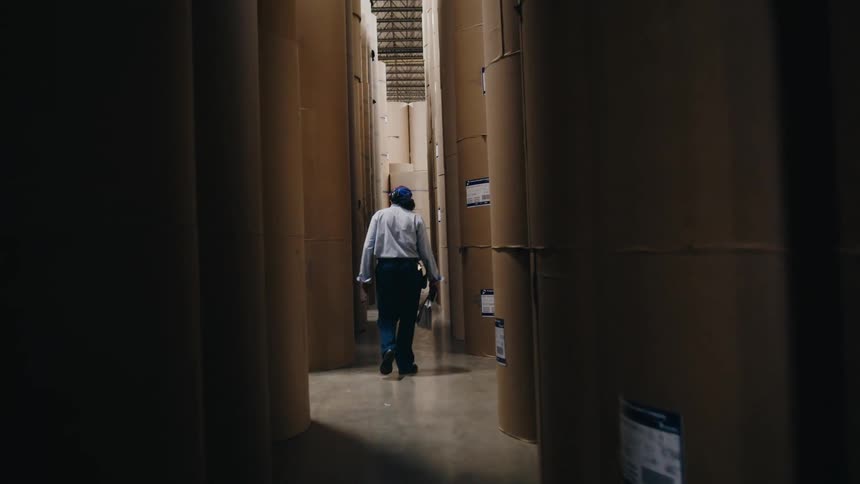 An employee is walking through a building that they work at