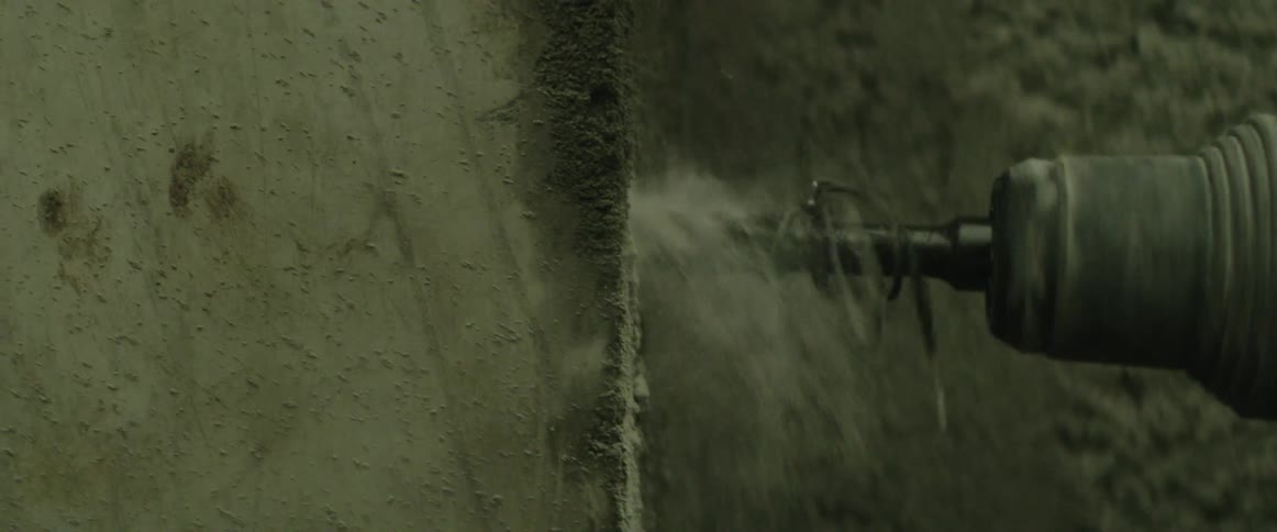 A drill being used on a concrete wall