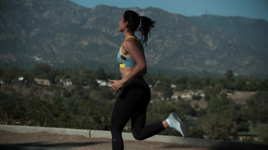 A woman is jogging outdoors in spring