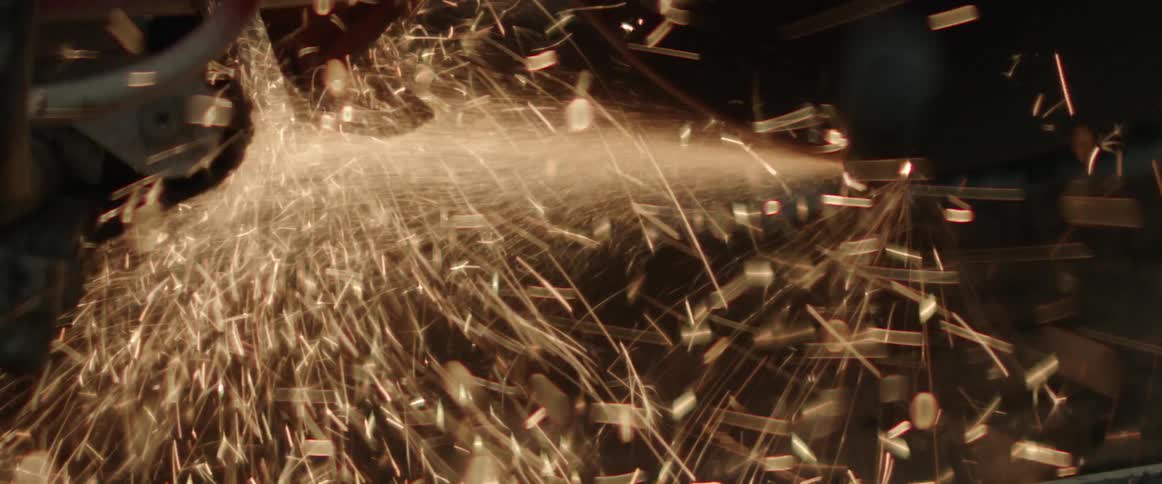 An employee cutting metal on a saw