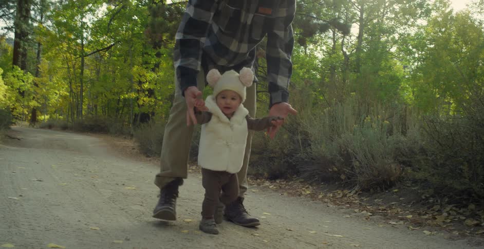 A man walks a baby on the hiking trail