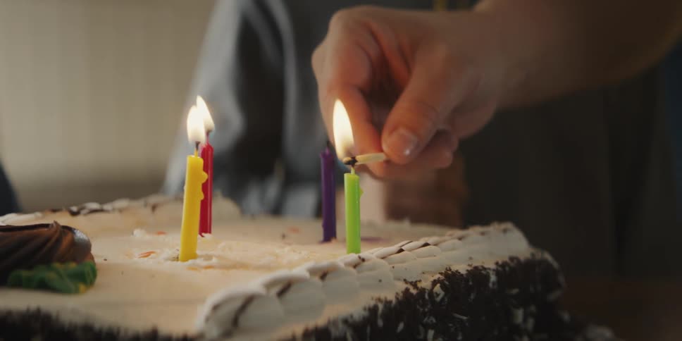 Candles on the birthday cake are lit