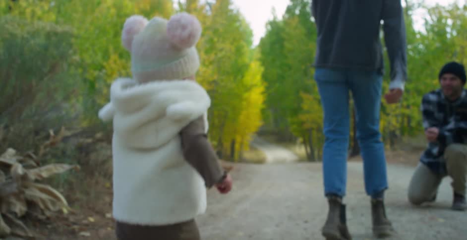A family is hiking together in a wooded area