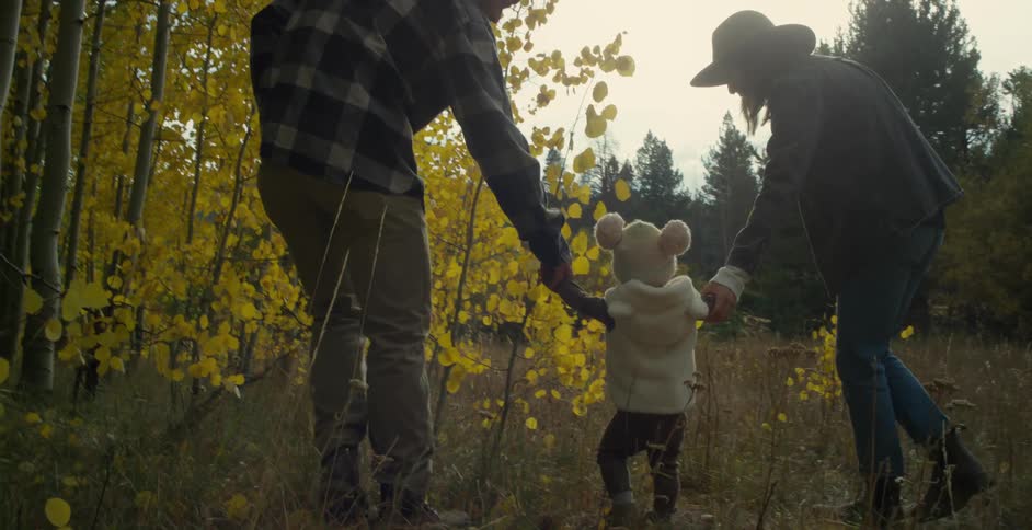 A family is hiking in the wilderness together at dusk