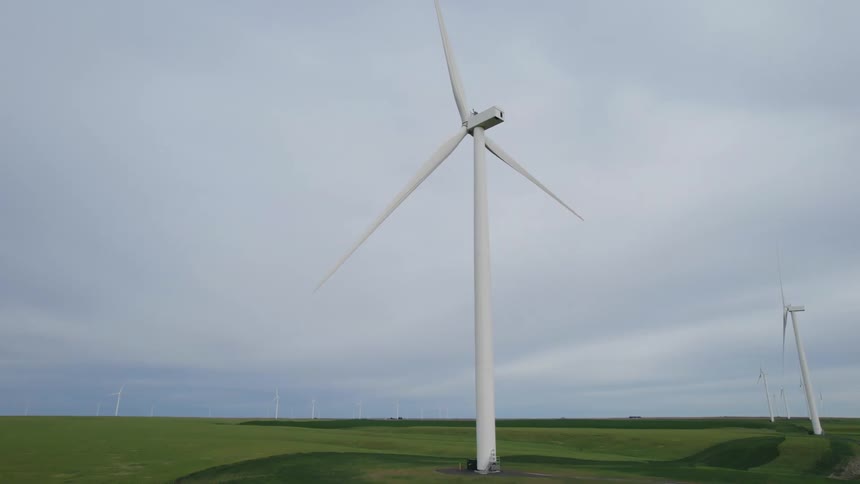 Wind turbines spin in an open field