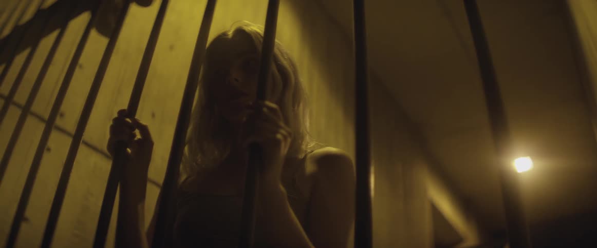 A woman is holding onto some metal bars