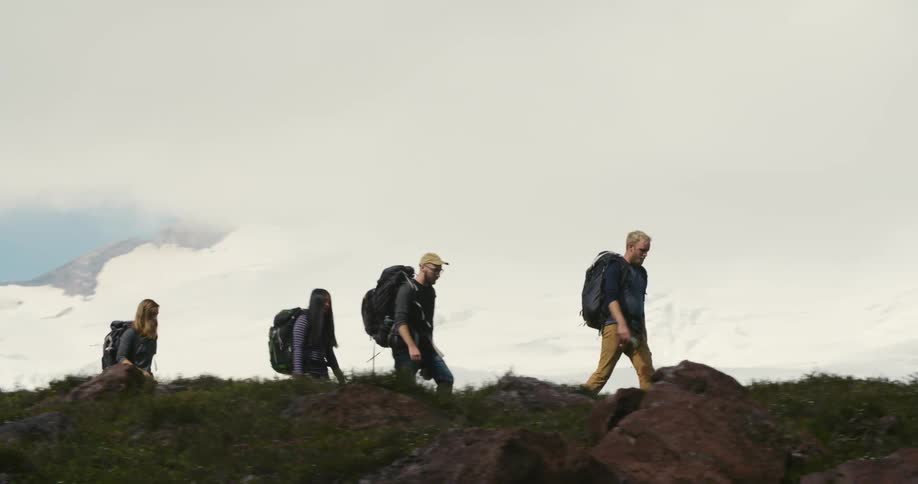 Four people are hiking on the mountain