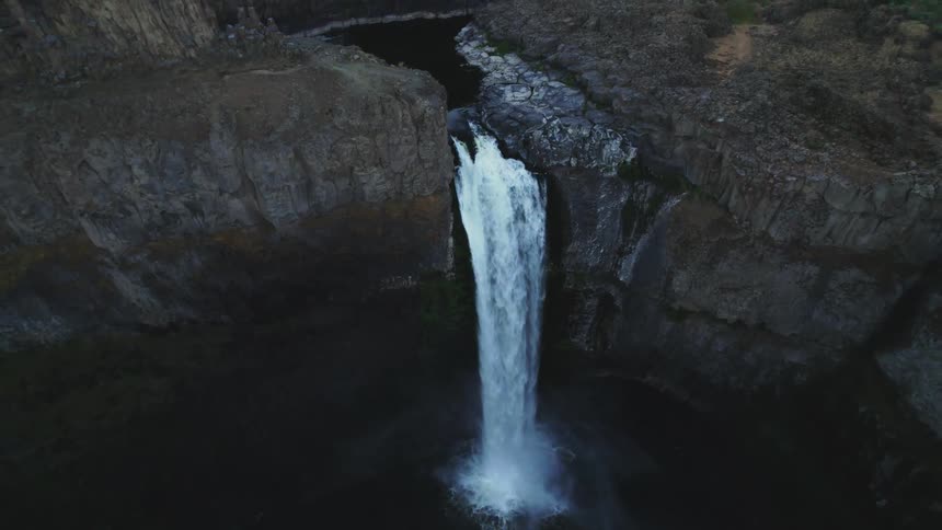 An aerial view of waterfall from a river