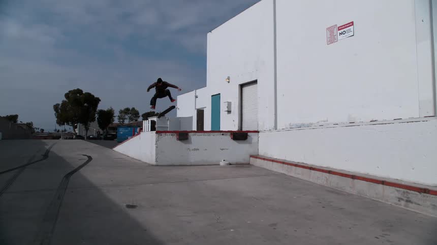 A man does a high jump on his skateboard