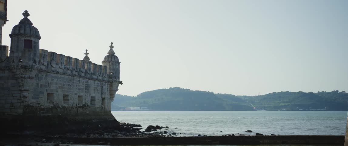 A building on a shoreline next to a lake in the daytime
