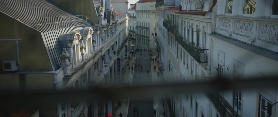 Aerial view of pedestrians walking through a city is displayed