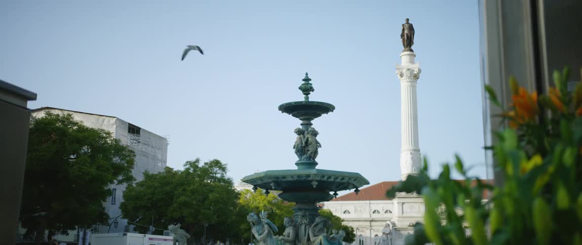 A statue is displayed in an urban city in spring