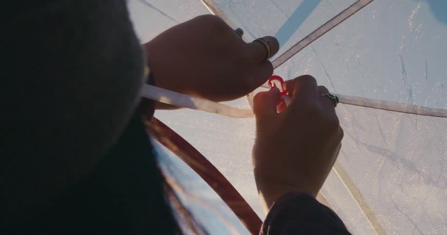 A female in a tent puts a clip on it