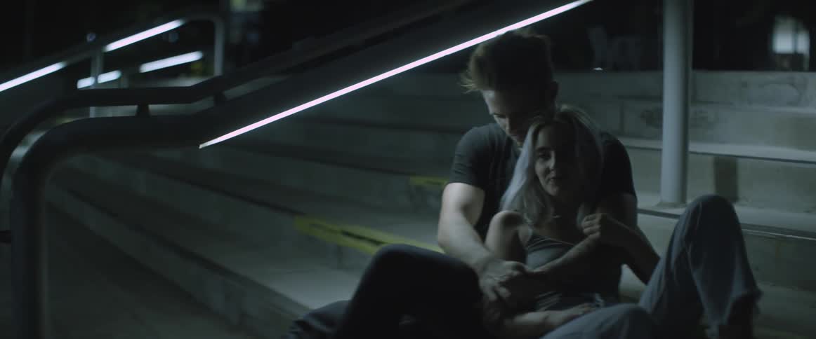 A man and woman sit on some stairs