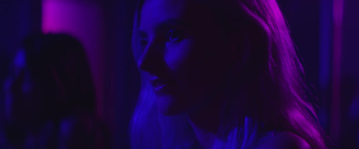 Close-up of a blonde woman in a club with not much action