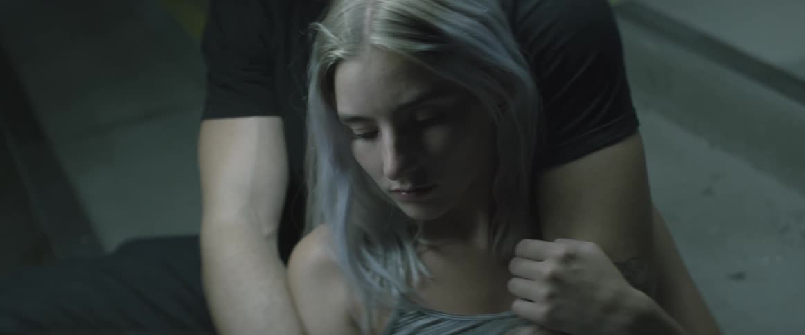 A man is holding a woman