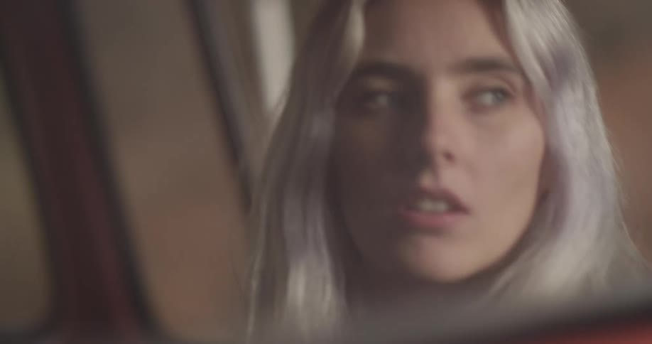 Woman riding in vehicle looking around