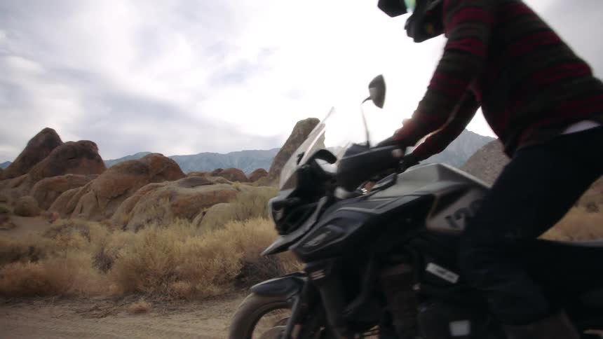 Two people riding dirt bikes outdoors