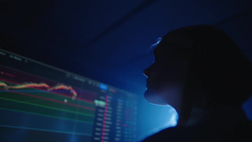 Man and woman are looking at a screen indoors