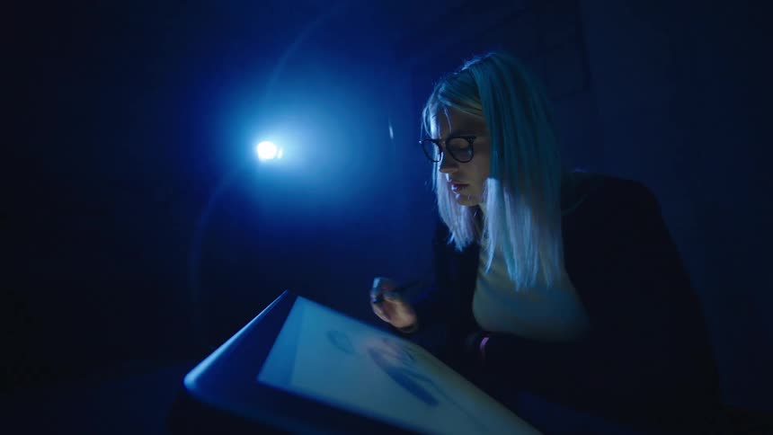 A woman is drawing on the tablet