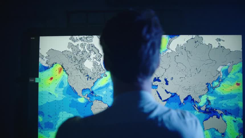A man is looking at a weather forecast on the display
