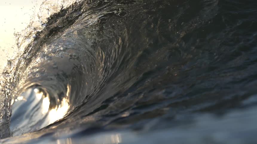 Ocean waves are moving in the sea at dusk