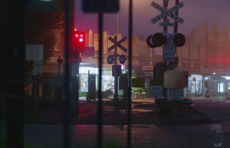 A rail way crossing in front of a building