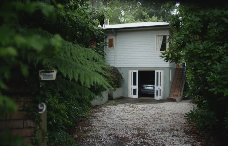 A car is parked in a garage attached to a house