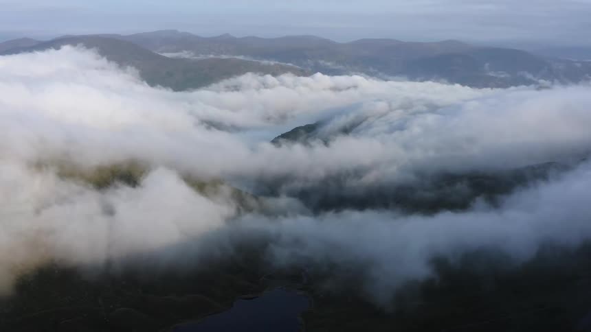 Mist over the mountains under a blue sky